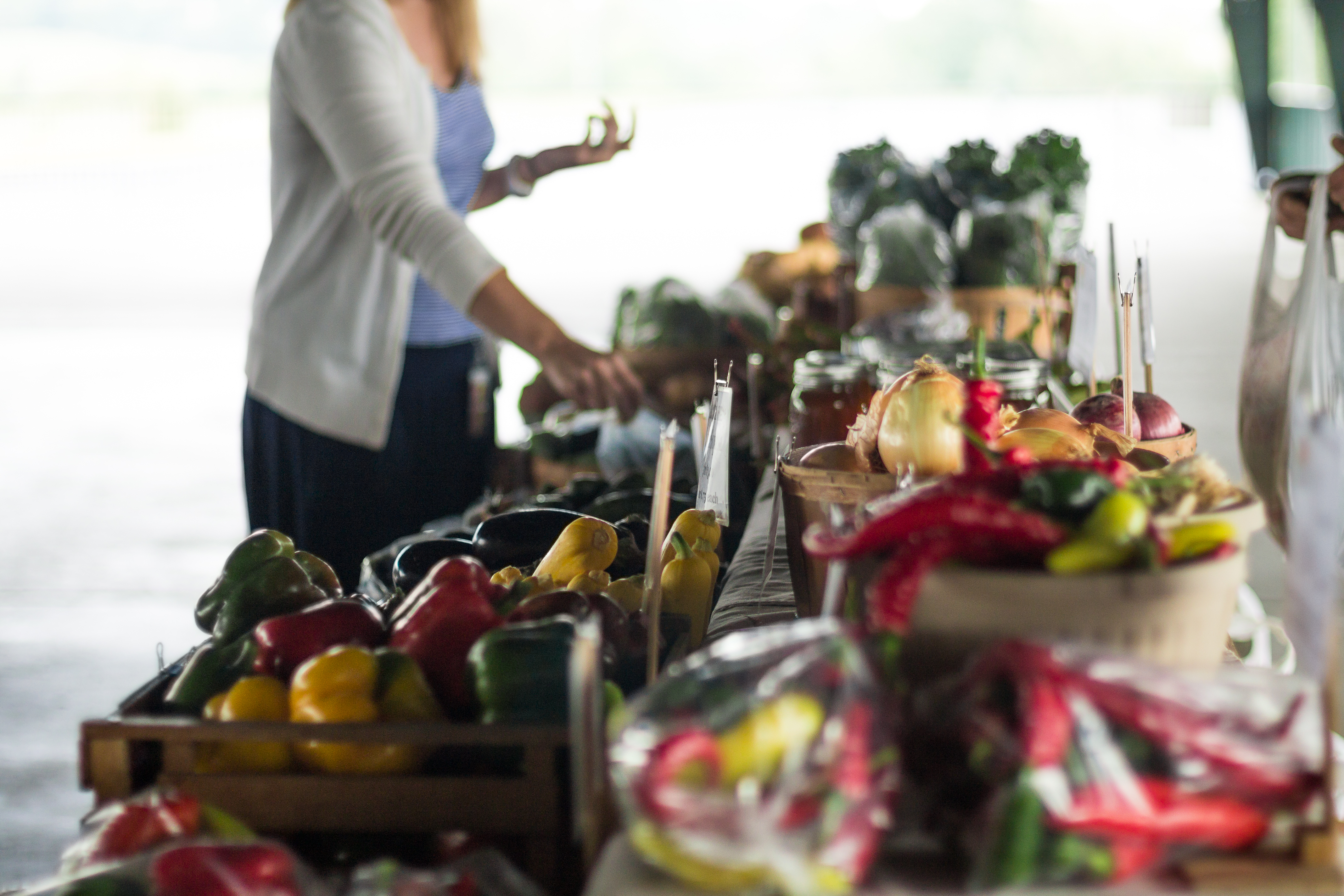 A farmers market table filled with local food products